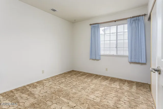 an empty room with a empty space and window