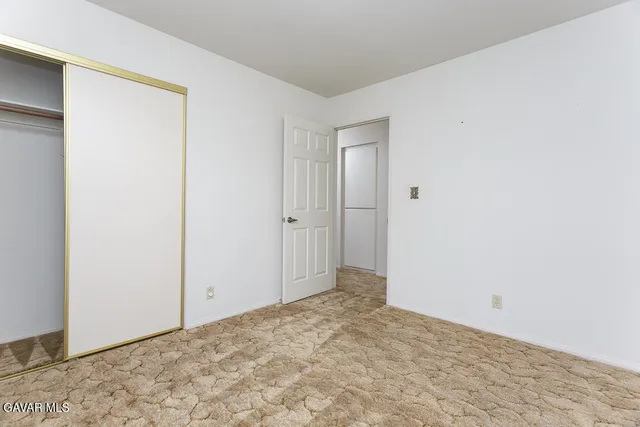 an aerial view of a houses with a street and green space