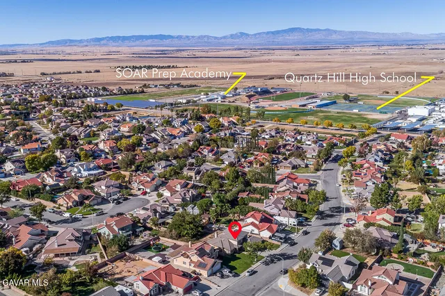 a view of a patio with a table chairs and backyard