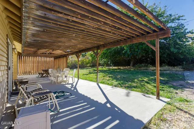 a view of a patio with table and chairs and wooden floor