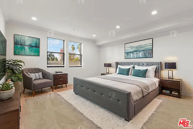 a spacious bedroom with a bed and a couch