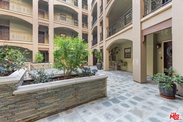 a view of a house with potted plants