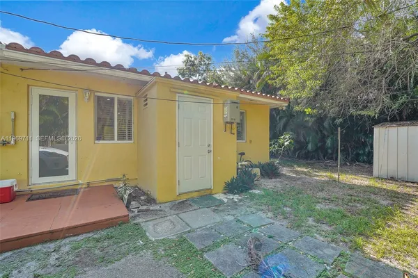 a yellow house with green space