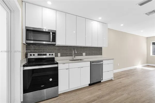a kitchen with a stove and a microwave