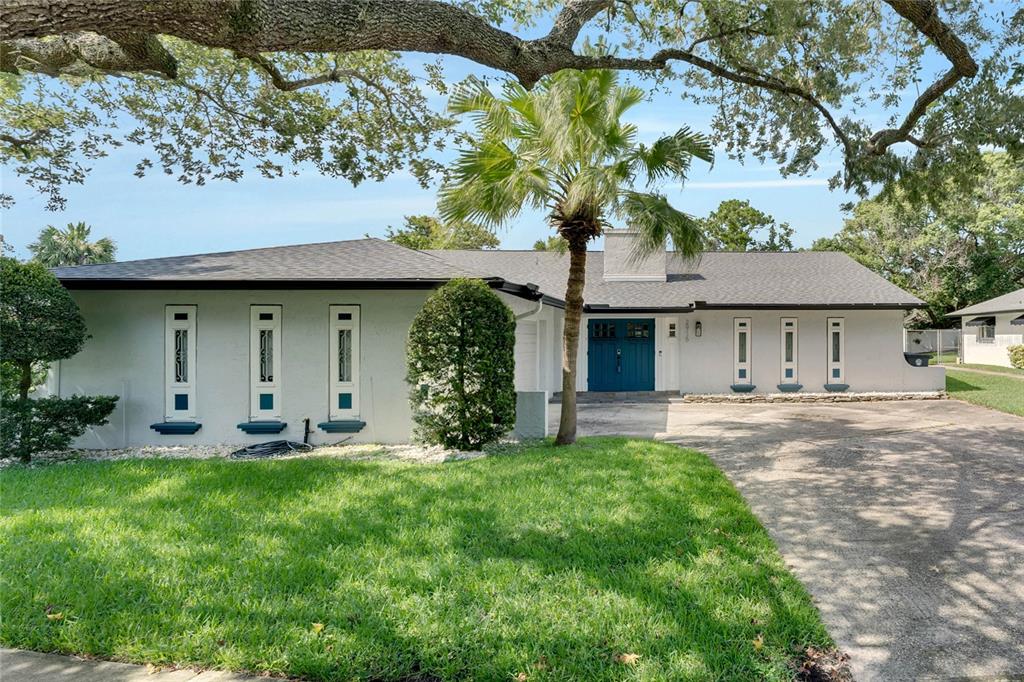 2915 Summerfield Road Winter Park, FL 32792 - Photo 1 of 1 a front view of a house with a garden and trees