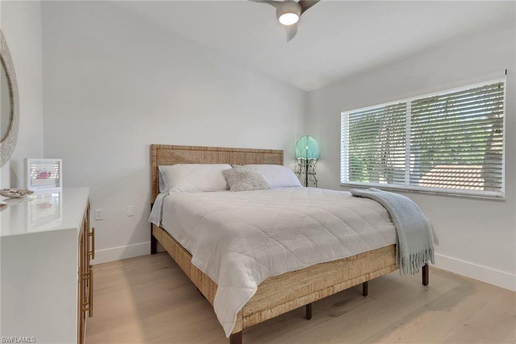2386 Magnolia Avenue, Unit 7816 Naples, FL 34112 - Photo 12 of 28 a large bed sitting in a bedroom next to a window