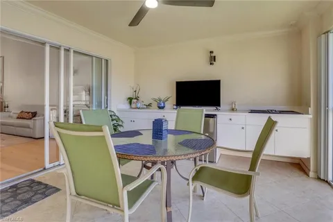 a view of a dining room with furniture and a potted plant