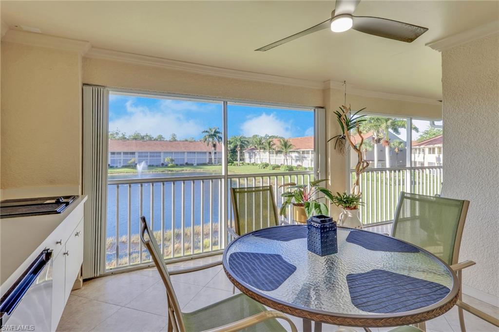 2386 Magnolia Avenue, Unit 7816 Naples, FL 34112 - Photo 16 of 28 a view of a dining room with furniture a chandelier and wooden floor