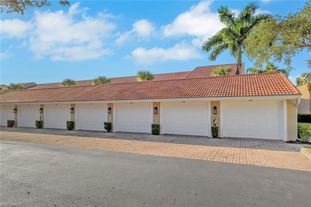 2386 Magnolia Avenue, Unit 7816 Naples, FL 34112 - Photo 18 of 28 a front view of a house with a garage