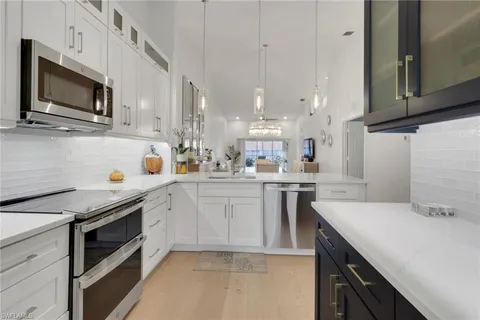 a kitchen with a sink a stove and microwave