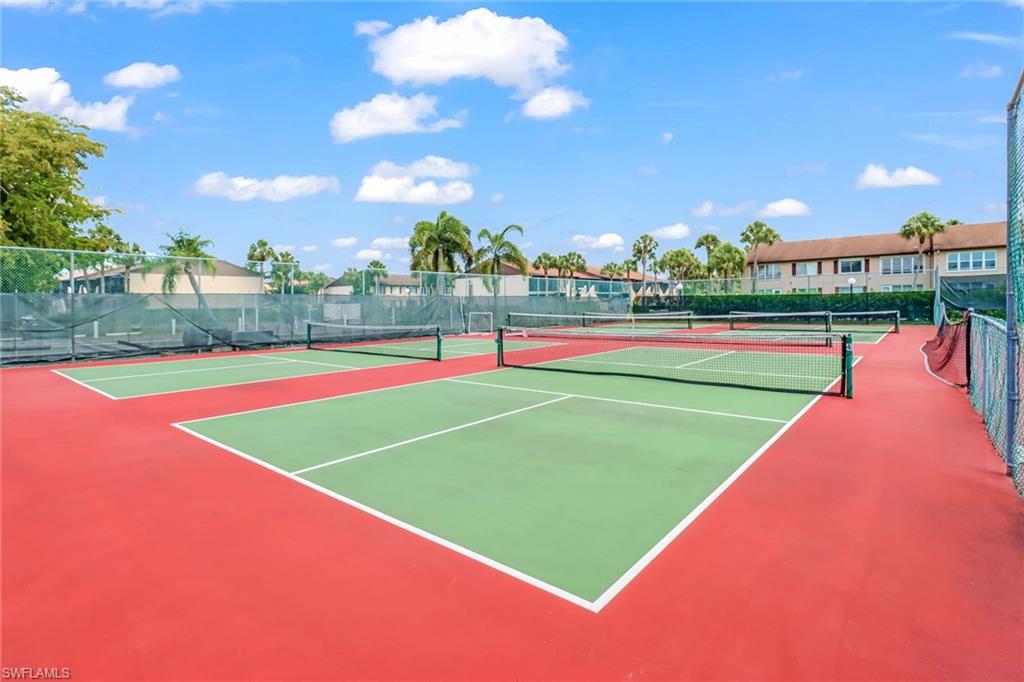 2386 Magnolia Avenue, Unit 7816 Naples, FL 34112 - Photo 26 of 28 a view of an outdoor space and tennis court