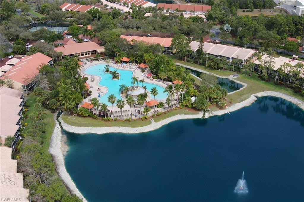 2386 Magnolia Avenue, Unit 7816 Naples, FL 34112 - Photo 28 of 28 an aerial view of a house with a garden and lake view