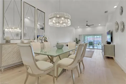 a view of a dining room with furniture and chandelier