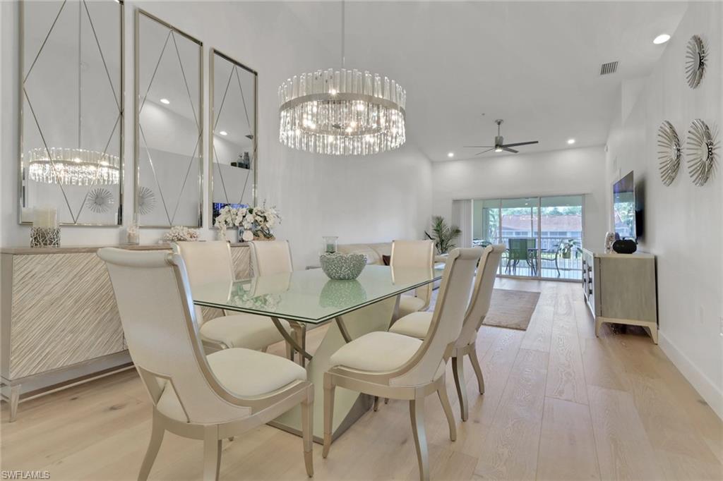 2386 Magnolia Avenue, Unit 7816 Naples, FL 34112 - Photo 6 of 28 a view of a dining room with furniture and chandelier