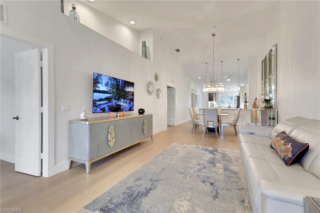 2386 Magnolia Avenue, Unit 7816 Naples, FL 34112 - Photo 7 of 28 a living room with furniture and a area with kitchen view