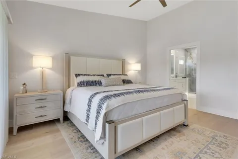 a bed room with a bed and a night stand