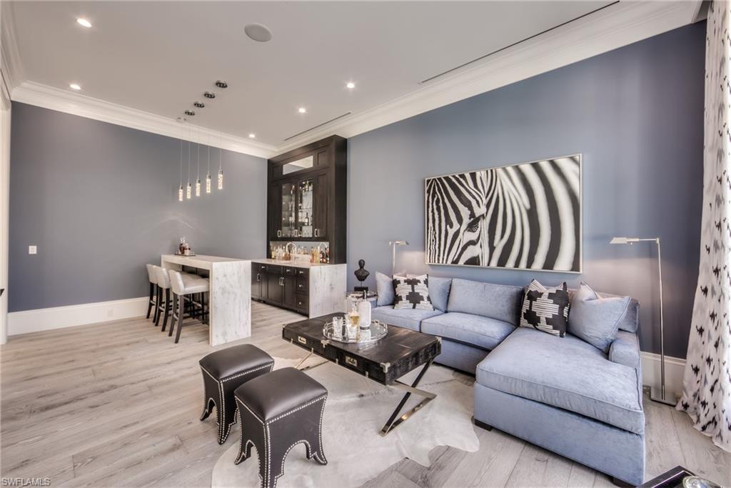 13981 Williston Way Naples, FL 34119 - Photo 7 of 13 a living room with furniture and a fireplace