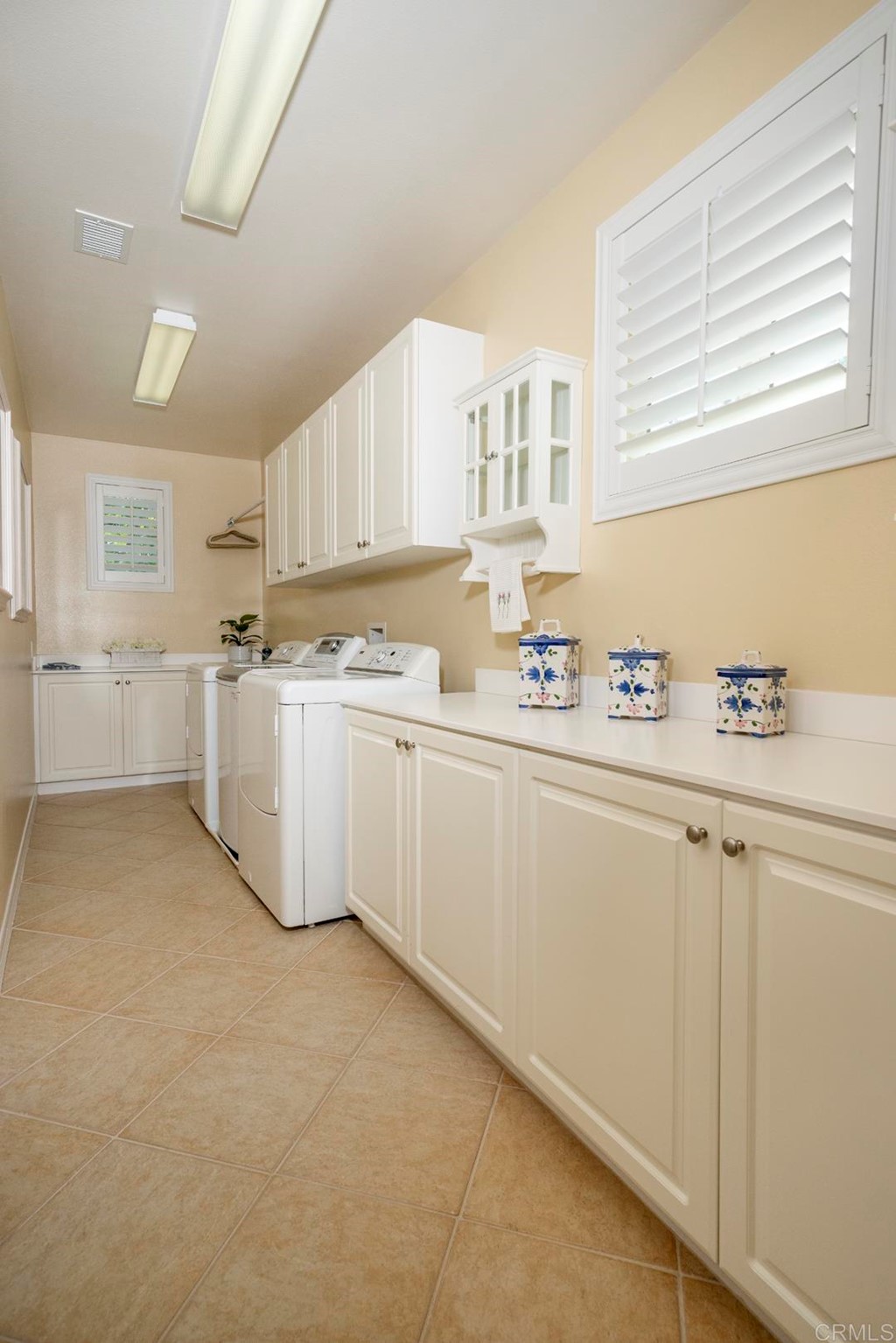 2887 Rancho Cortes Carlsbad, CA 92009 - Photo 39 of 46 a utility room with cabinets washer and dryer