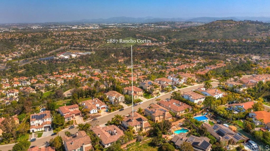 2887 Rancho Cortes Carlsbad, CA 92009 - Photo 43 of 46 an aerial view of residential houses with outdoor space and trees