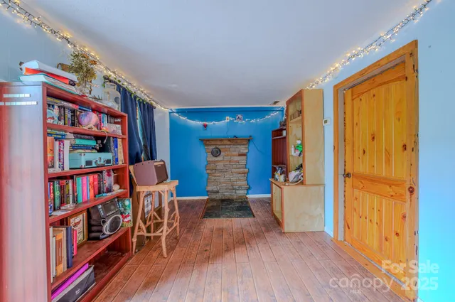 a view of living room with furniture and wooden floor