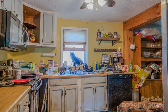 a kitchen with refrigerator cabinets and wooden floor