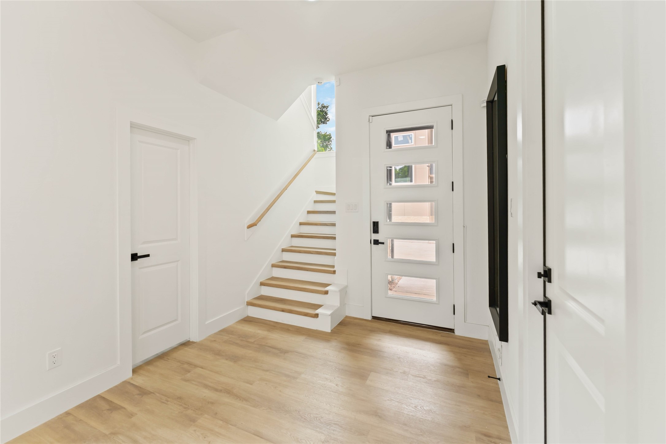 6539 Sealey Street Houston, TX 77091 - Photo 6 of 28 a view of a hallway with wooden floor and entryway