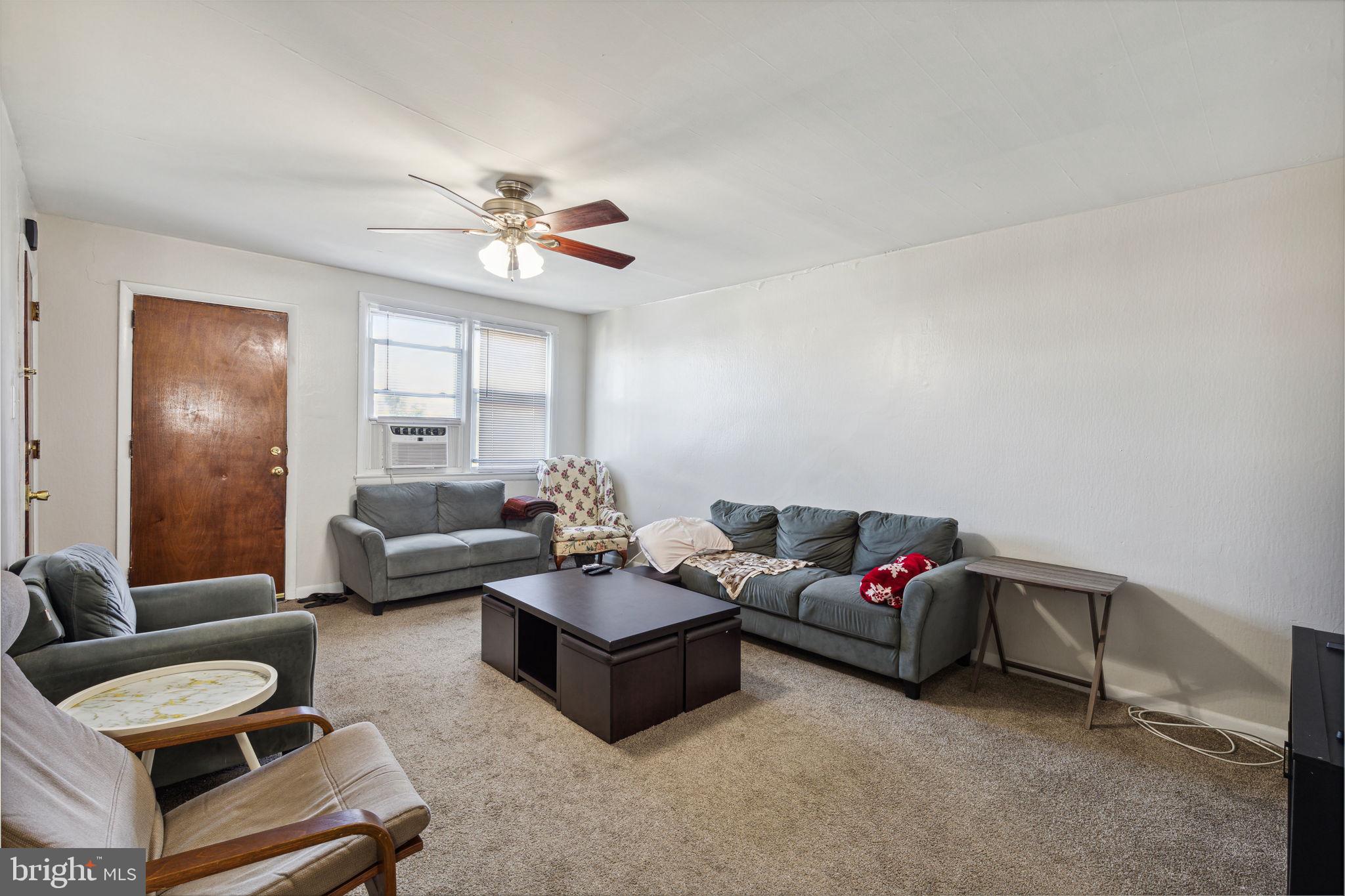 392 Beverly Boulevard Upper Darby, PA 19082 - Photo 7 of 26 a living room with furniture and a chandelier