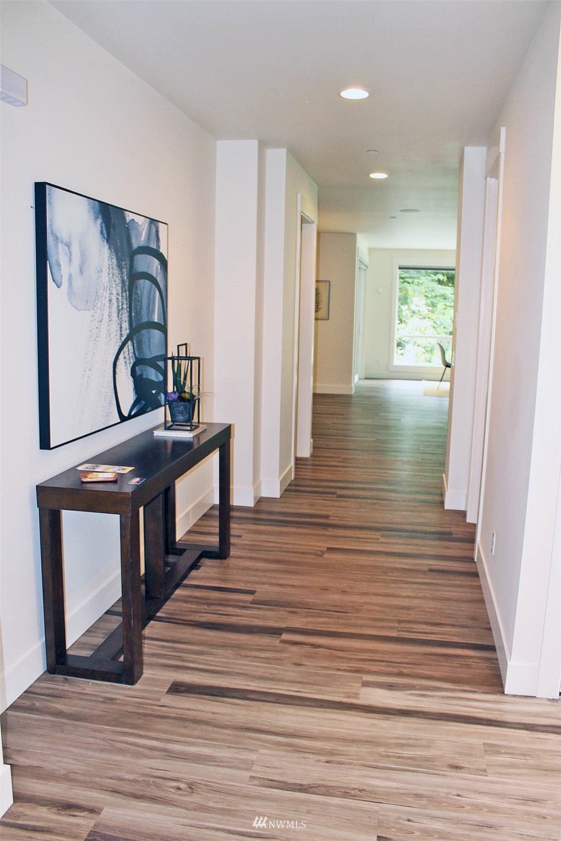 17720 190th Avenue Southeast Renton, WA 98058 - Photo 19 of 40 a view of a hallway with wooden floor and furniture