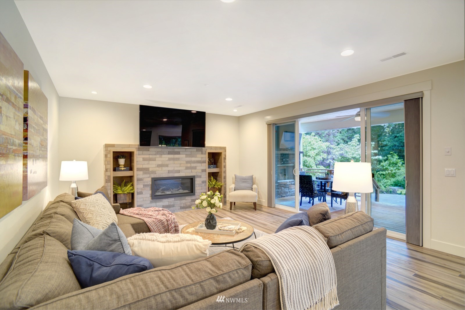 17720 190th Avenue Southeast Renton, WA 98058 - Photo 7 of 40 a living room with furniture a fireplace a flat screen tv and a large window