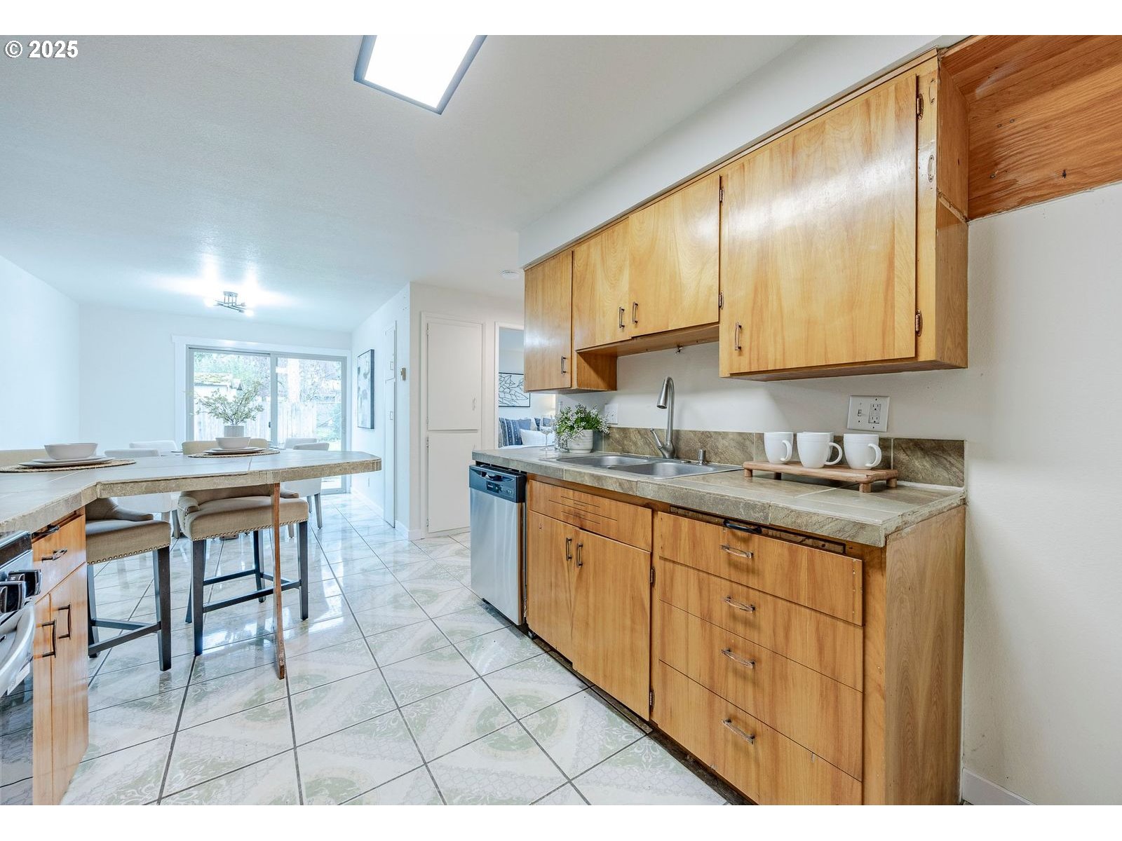 5982 G Street Springfield, OR 97478 - Photo 13 of 39 a kitchen with granite countertop a sink a stove cabinets and living room view