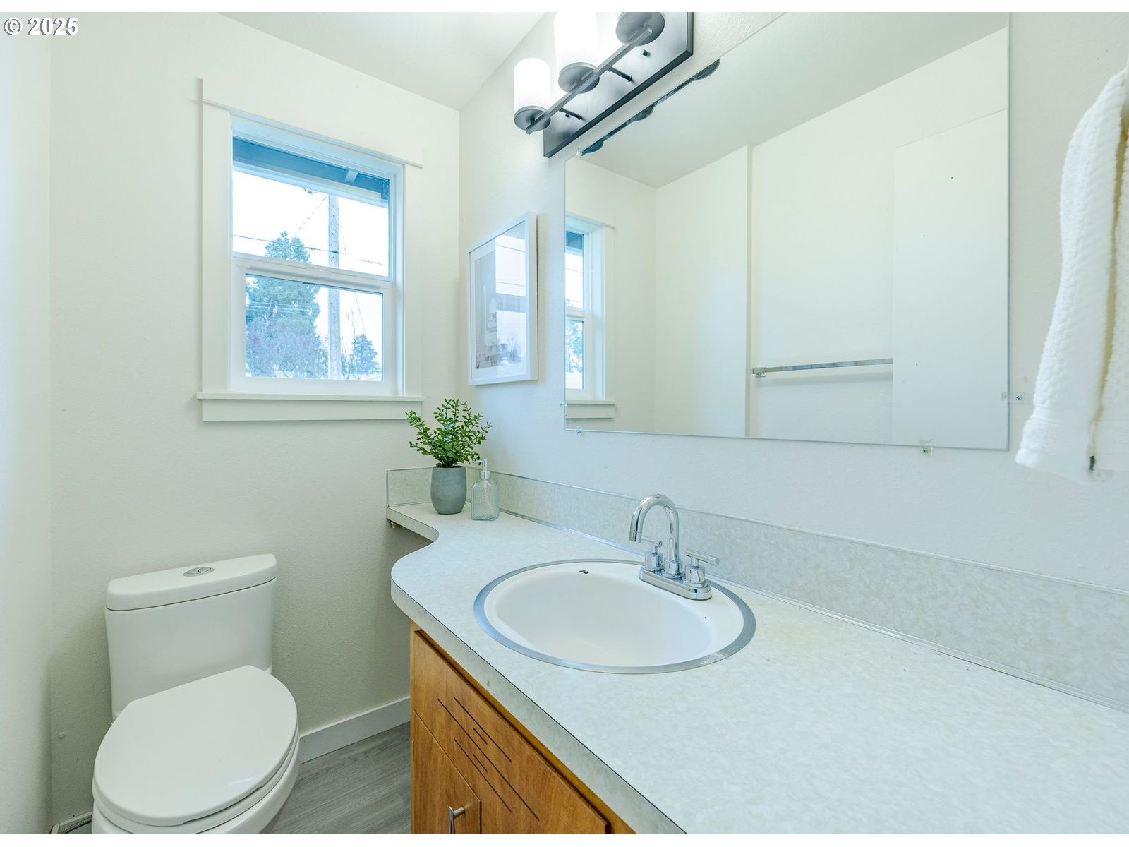 5982 G Street Springfield, OR 97478 - Photo 24 of 39 a bathroom with a toilet sink and mirror