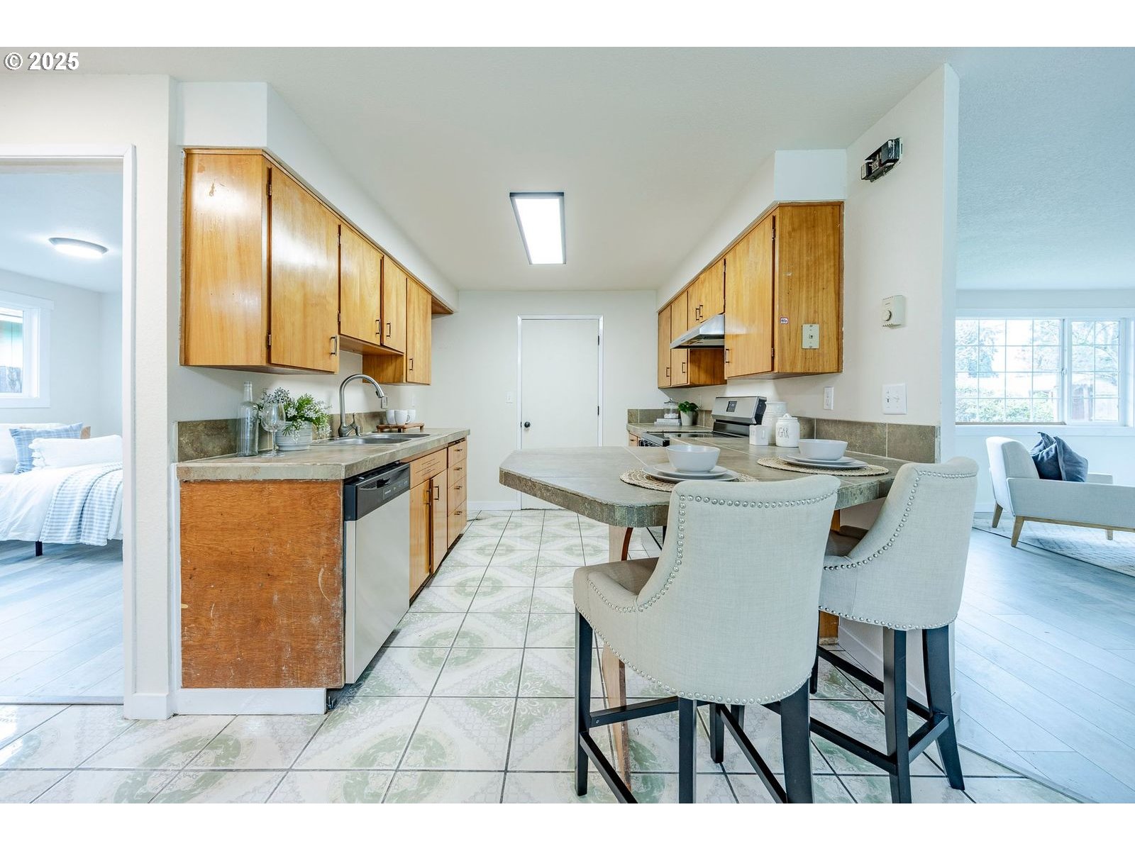 5982 G Street Springfield, OR 97478 - Photo 10 of 39 a kitchen with stainless steel appliances a sink cabinets and wooden floor