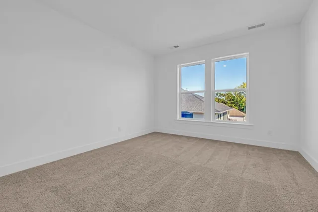 a bathroom with a double vanity sink mirror and shower