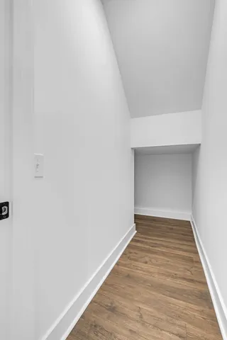 a view of a closet area with an empty room