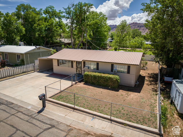 527 Palisade Drive Moab, UT 84532 - Photo 33 of 51 Ranch-style house featuring driveway, metal roof, and a mountain view