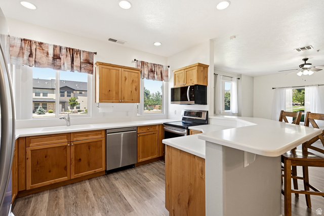 1177 Northfield Road, Unit 26 Cedar City, UT 84721 - Photo 11 of 45 Kitchen featuring wood cabinetry, stainless steel appliances, white countertops, and wood-finish flooring