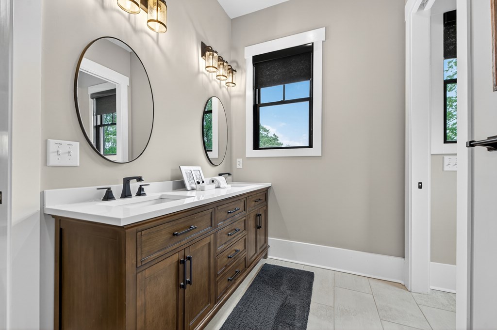 658 Old Toccoa Loop Mineral Bluff, GA 30559 - Photo 33 of 74 a bathroom with a double vanity sink and a mirror
