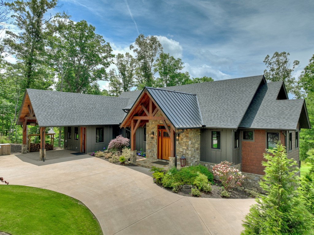 658 Old Toccoa Loop Mineral Bluff, GA 30559 - Photo 66 of 74 a front view of a house with a garden and trees