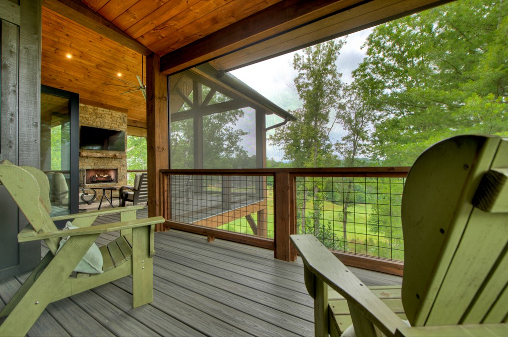 658 Old Toccoa Loop Mineral Bluff, GA 30559 - Photo 10 of 74 a view of a balcony with wooden floor and furniture