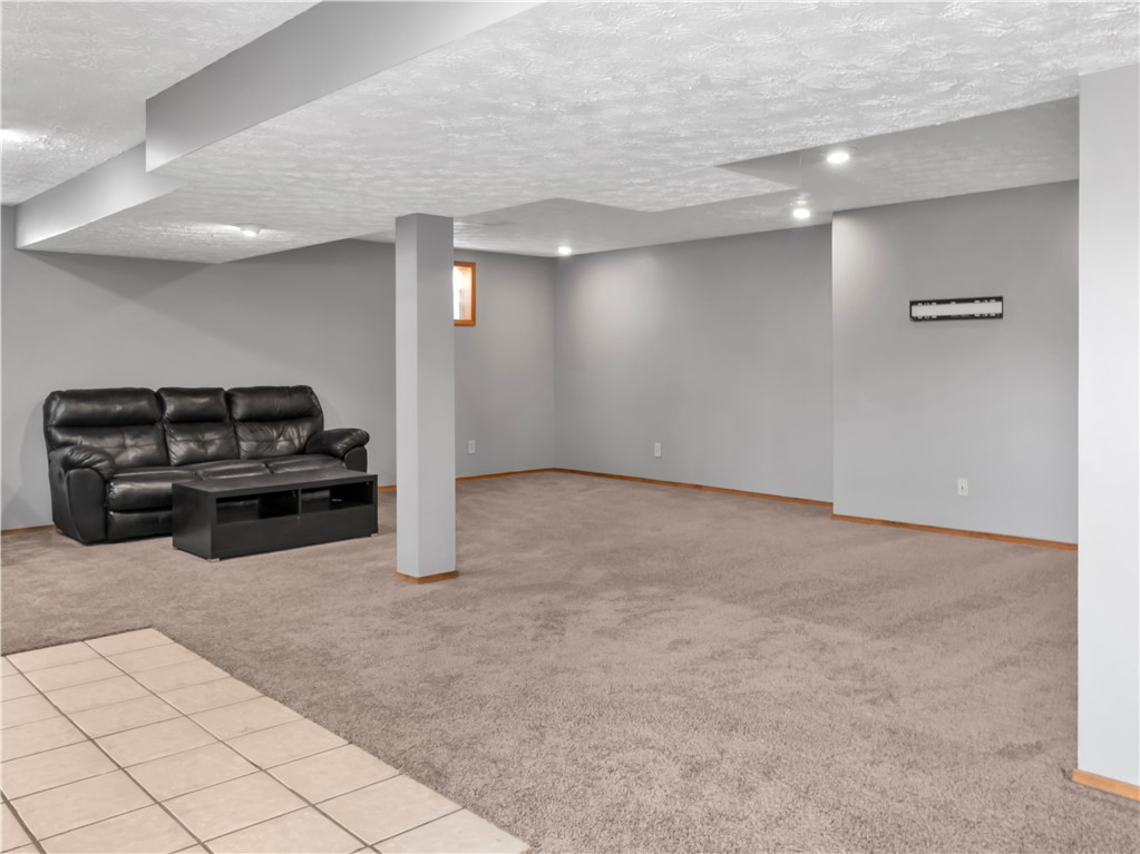 25 Callaway Springboro, OH 45066 - Photo 41 of 51 This expansive basement offers versatile living space, featuring recessed lighting and a blend of carpet and tile flooring.