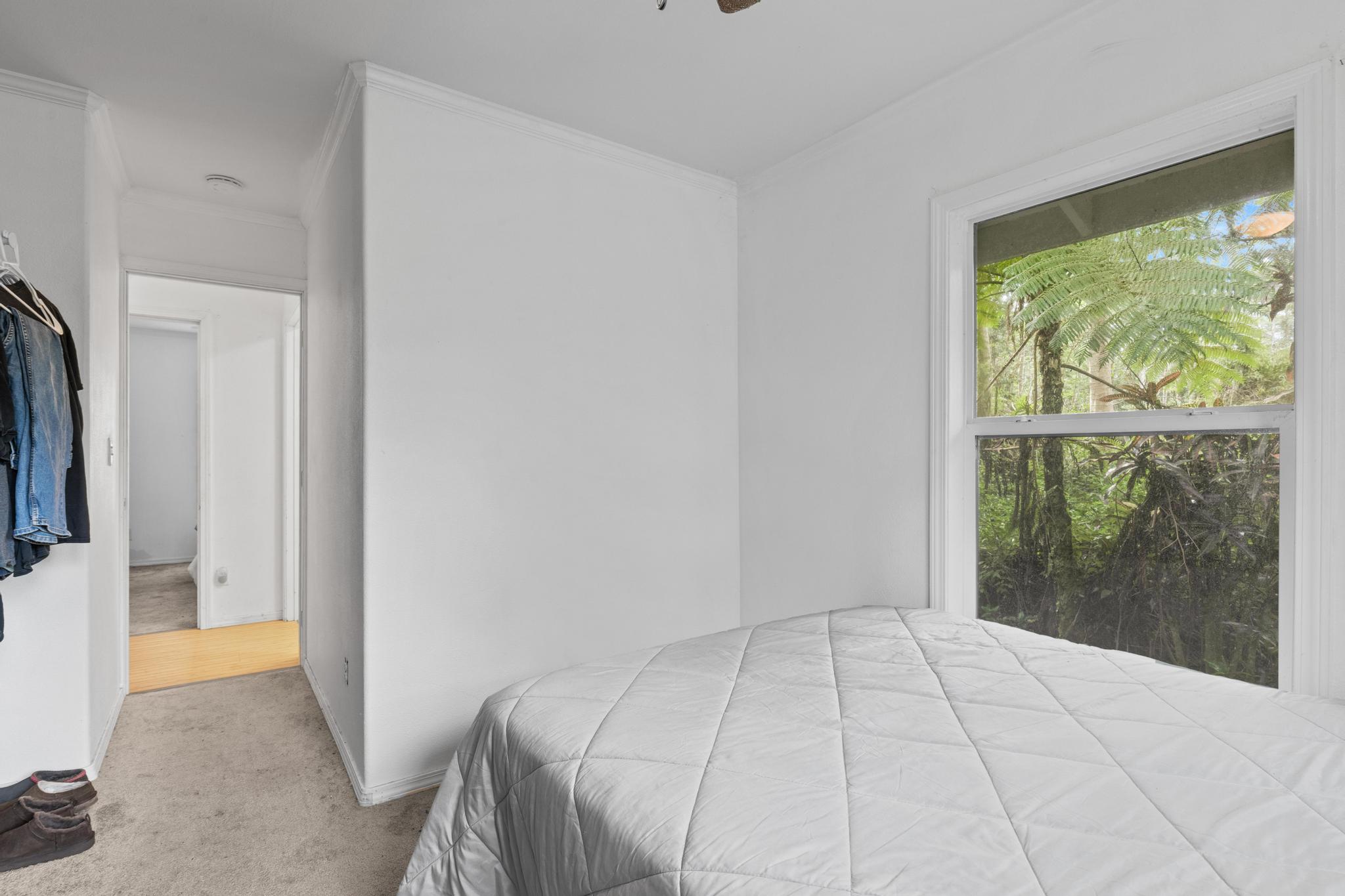 14-823 Seaview Road Pahoa, HI 96778 - Photo 11 of 23 a view of a bedroom with a bed and a window