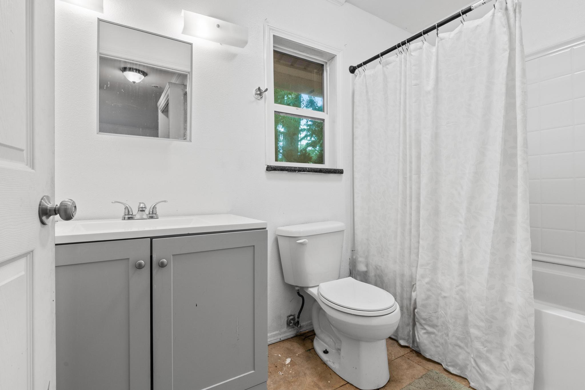 14-823 Seaview Road Pahoa, HI 96778 - Photo 13 of 23 a bathroom with a sink a toilet and a mirror