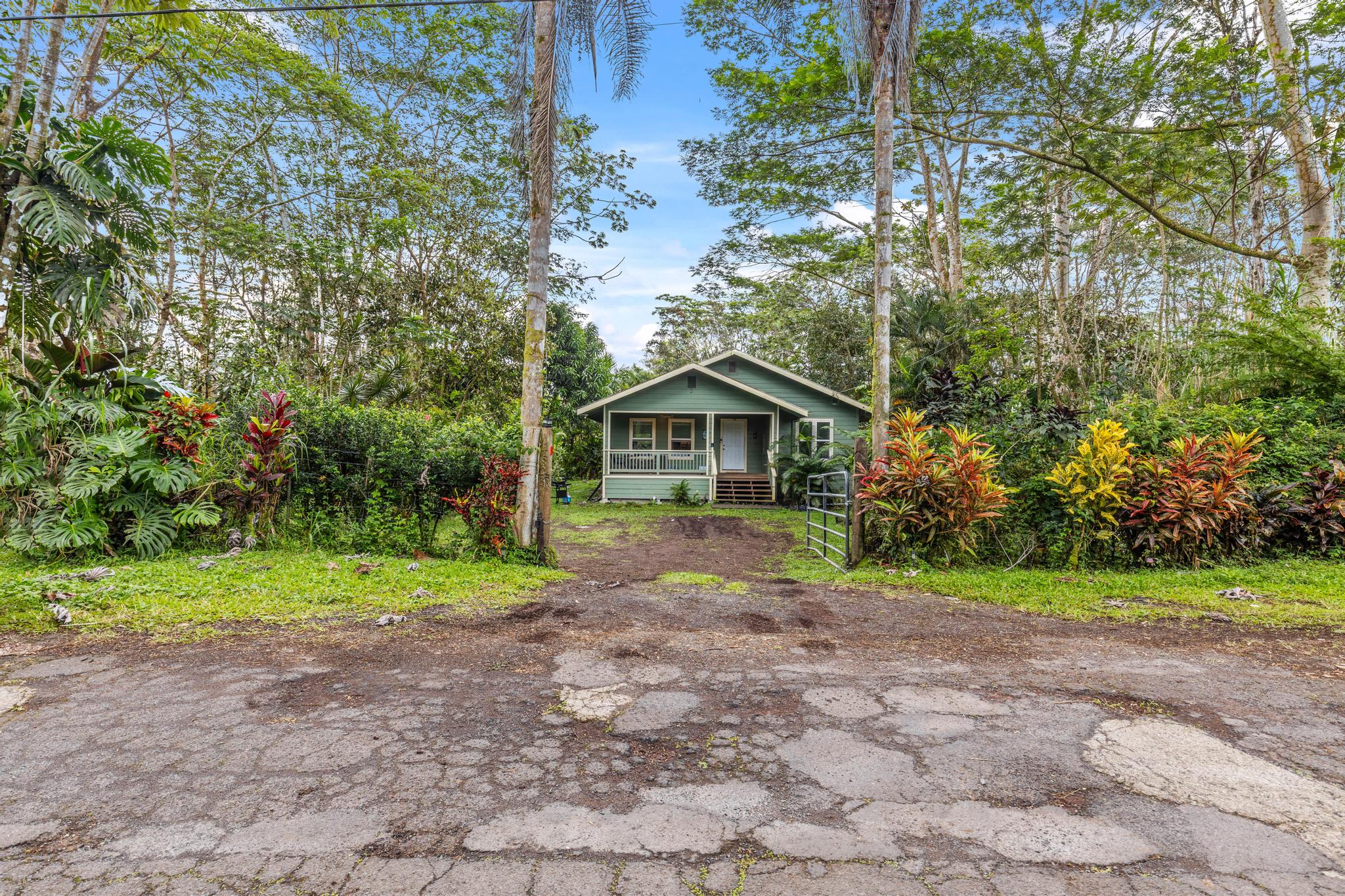 14-823 Seaview Road Pahoa, HI 96778 - Photo 17 of 23 a front view of a house with a yard and trees