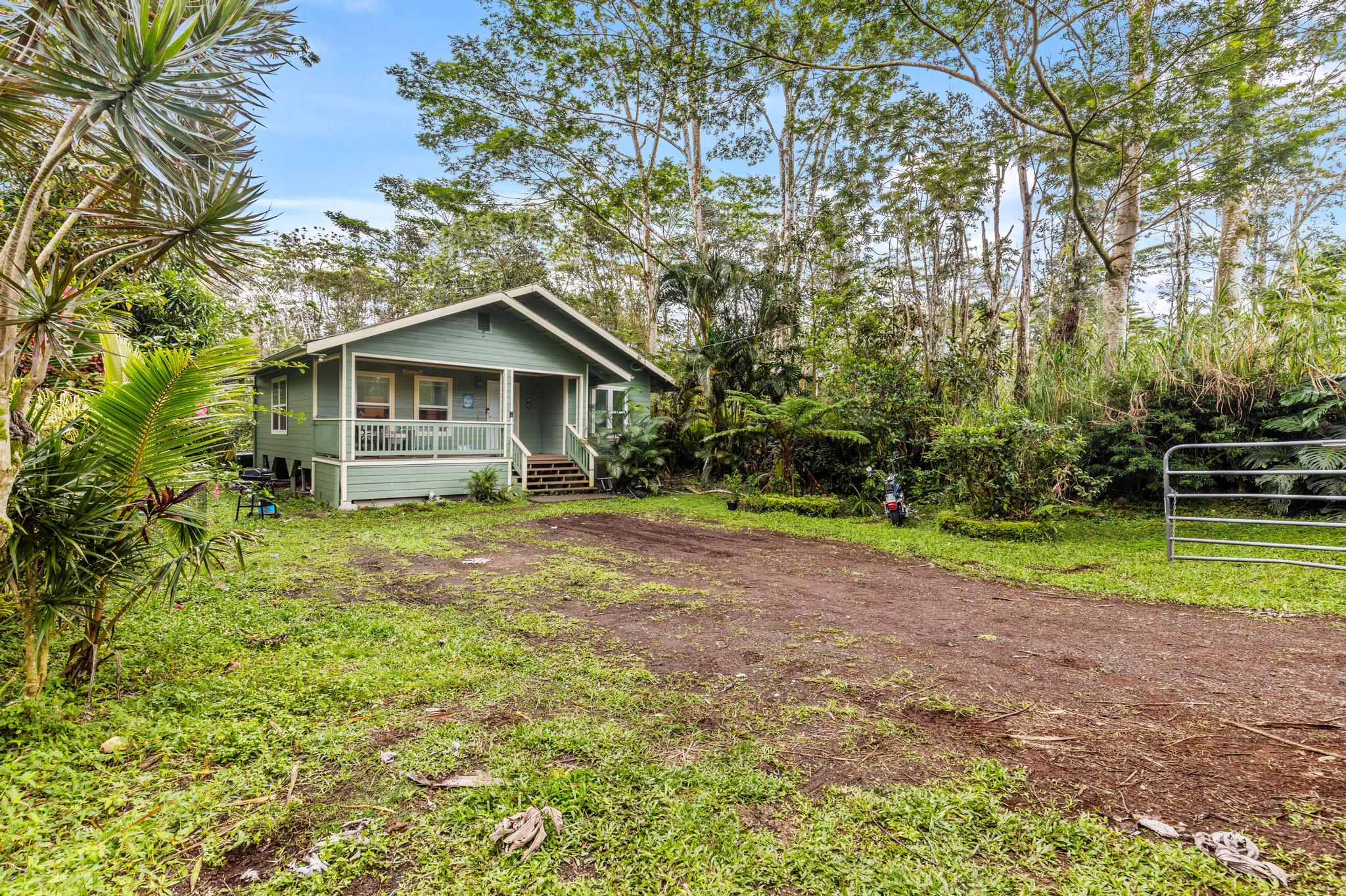 14-823 Seaview Road Pahoa, HI 96778 - Photo 19 of 23 a front view of a house with garden