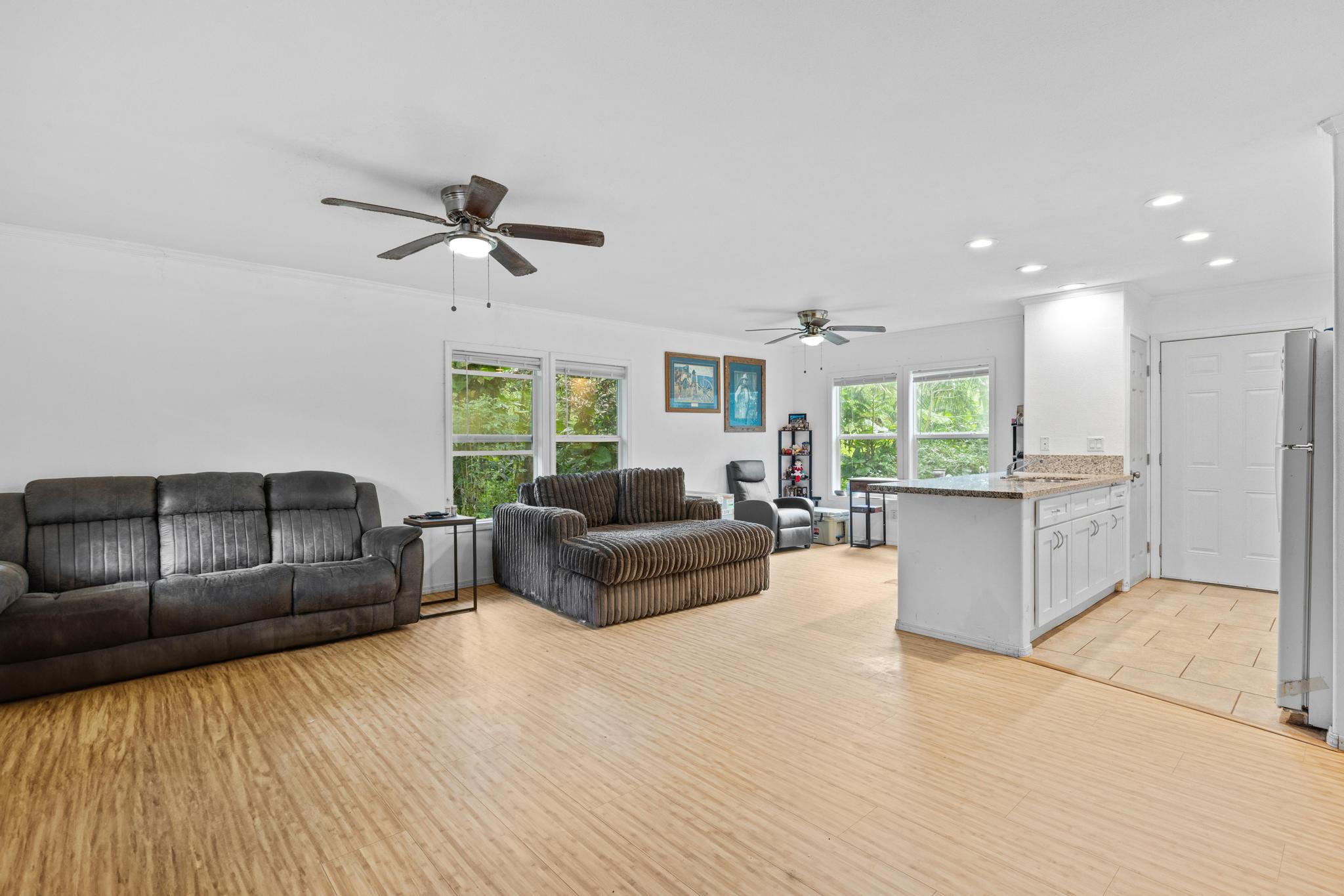 14-823 Seaview Road Pahoa, HI 96778 - Photo 3 of 23 a living room with furniture and a chandelier