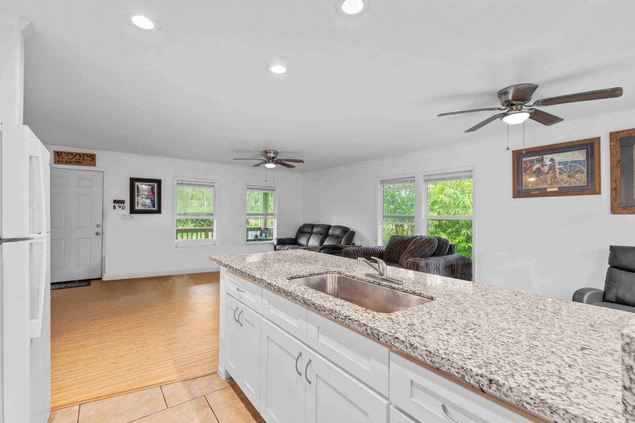 14-823 Seaview Road Pahoa, HI 96778 - Photo 8 of 23 a kitchen with granite countertop a sink a counter top space and living room view