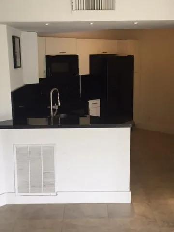 a kitchen with a sink and a refrigerator
