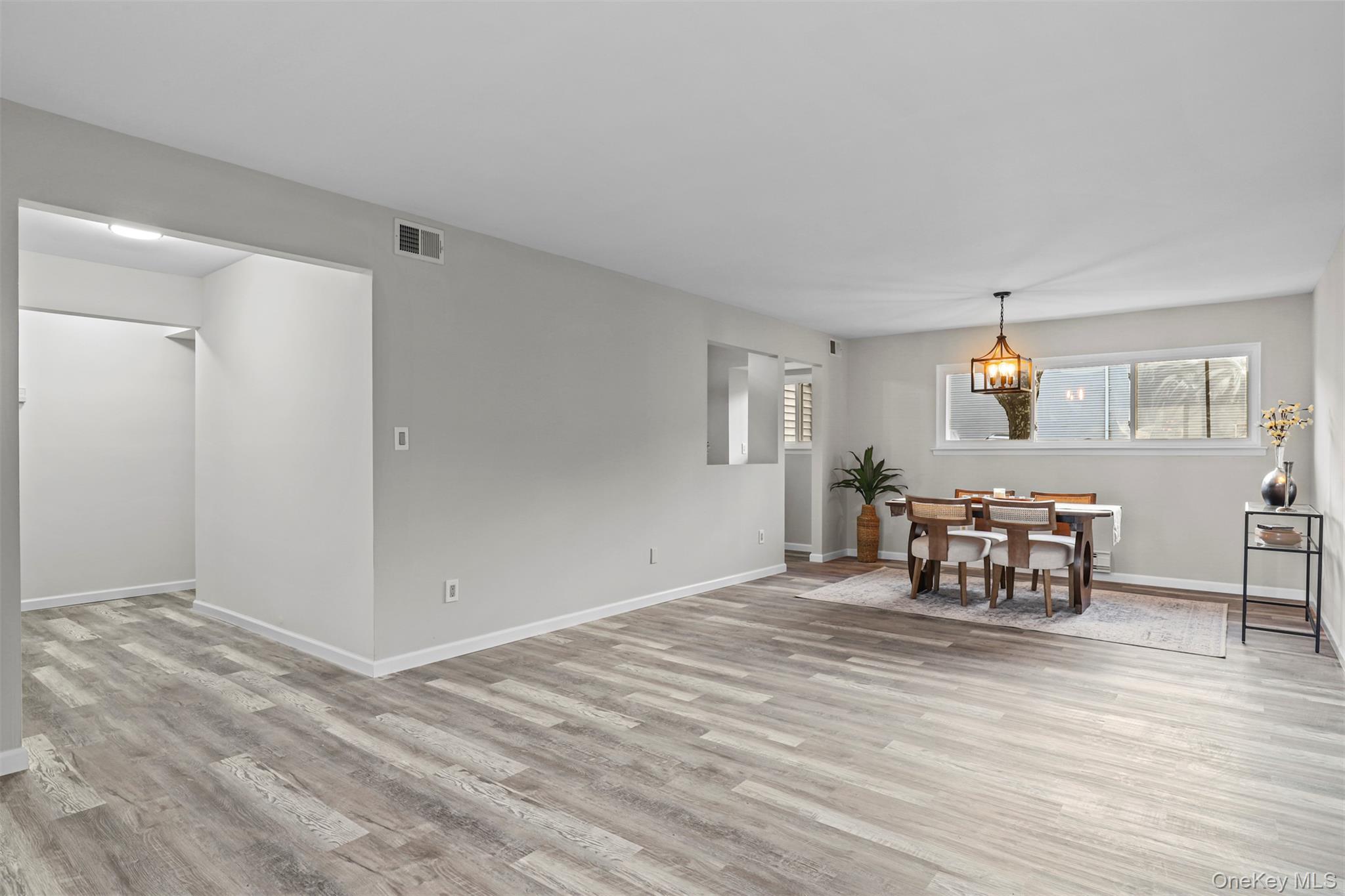 208 Harris Road, Unit D4A Bedford Hills, NY 10507 - Photo 3 of 13 a view of a livingroom with furniture and chandelier fan