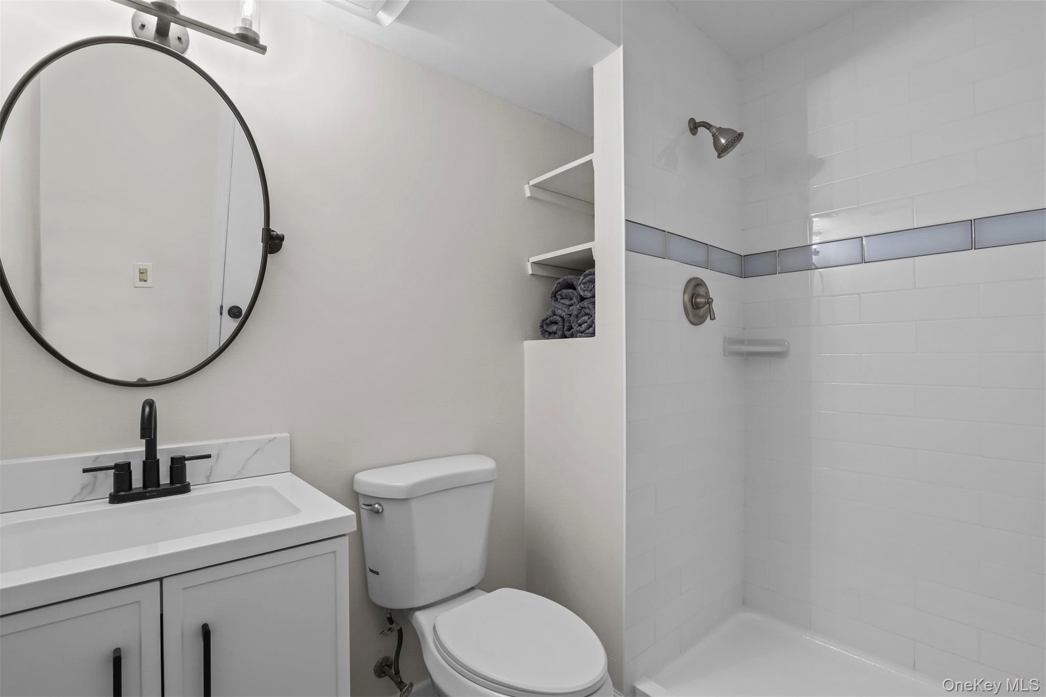 208 Harris Road, Unit D4A Bedford Hills, NY 10507 - Photo 5 of 13 a bathroom with a sink a toilet and a mirror