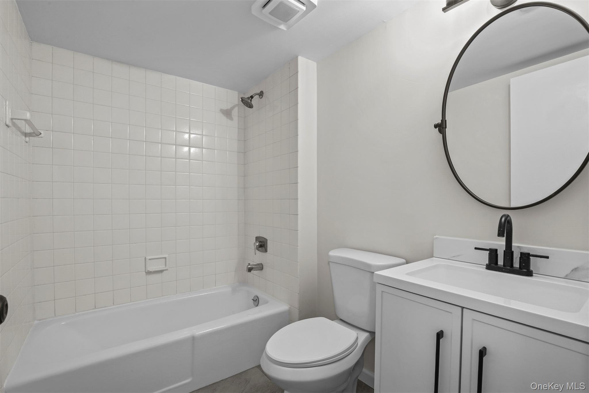 208 Harris Road, Unit D4A Bedford Hills, NY 10507 - Photo 6 of 13 a bathroom with a sink a toilet and a mirror